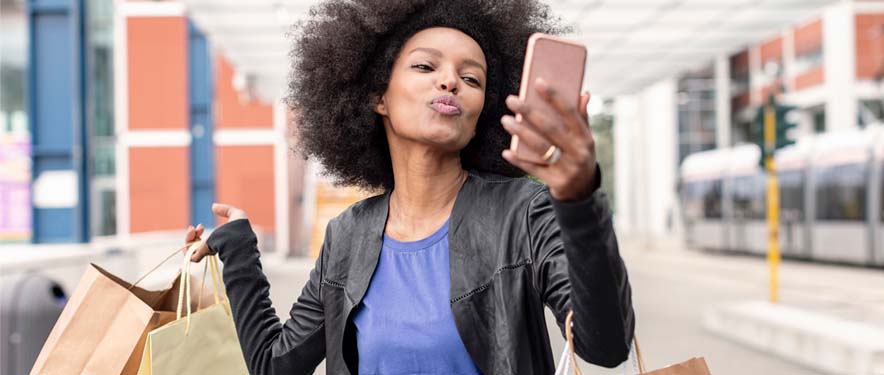 Woman on a shopping spree taking a selfie 